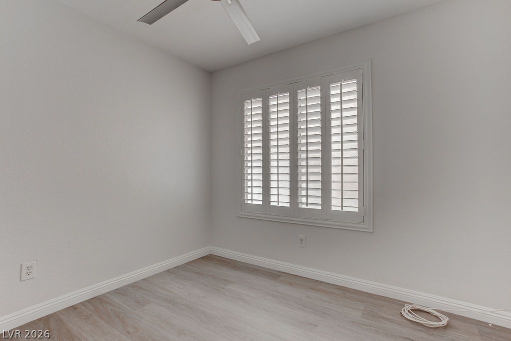1416 Walstone Road North Las Vegas, NV 89031 - Photo 23 of 47 Plantation shutters adorn a well-lit interior, complemented by a ceiling fan for comfortable airflow.