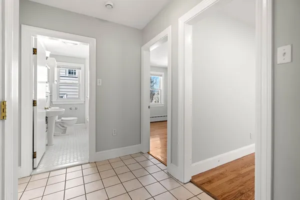 a view of a bathroom from a corridor