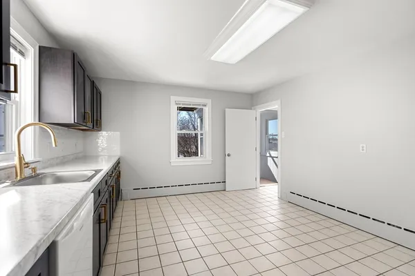 a kitchen with a sink cabinets and window