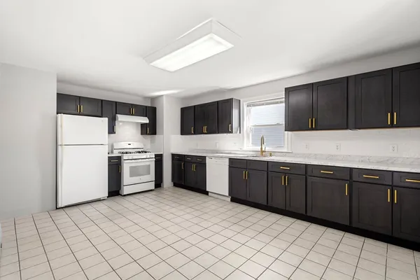 a kitchen with stainless steel appliances a refrigerator sink and microwave