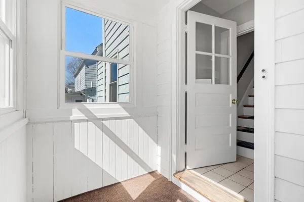 a view of entryway and hall with wooden floor