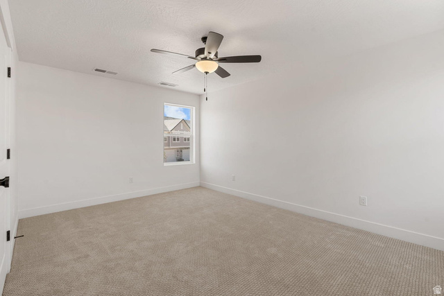 523 West Olive Lane St. George, UT 84790 - Photo 32 of 47 Empty room featuring carpet, ceiling fan, and a textured ceiling