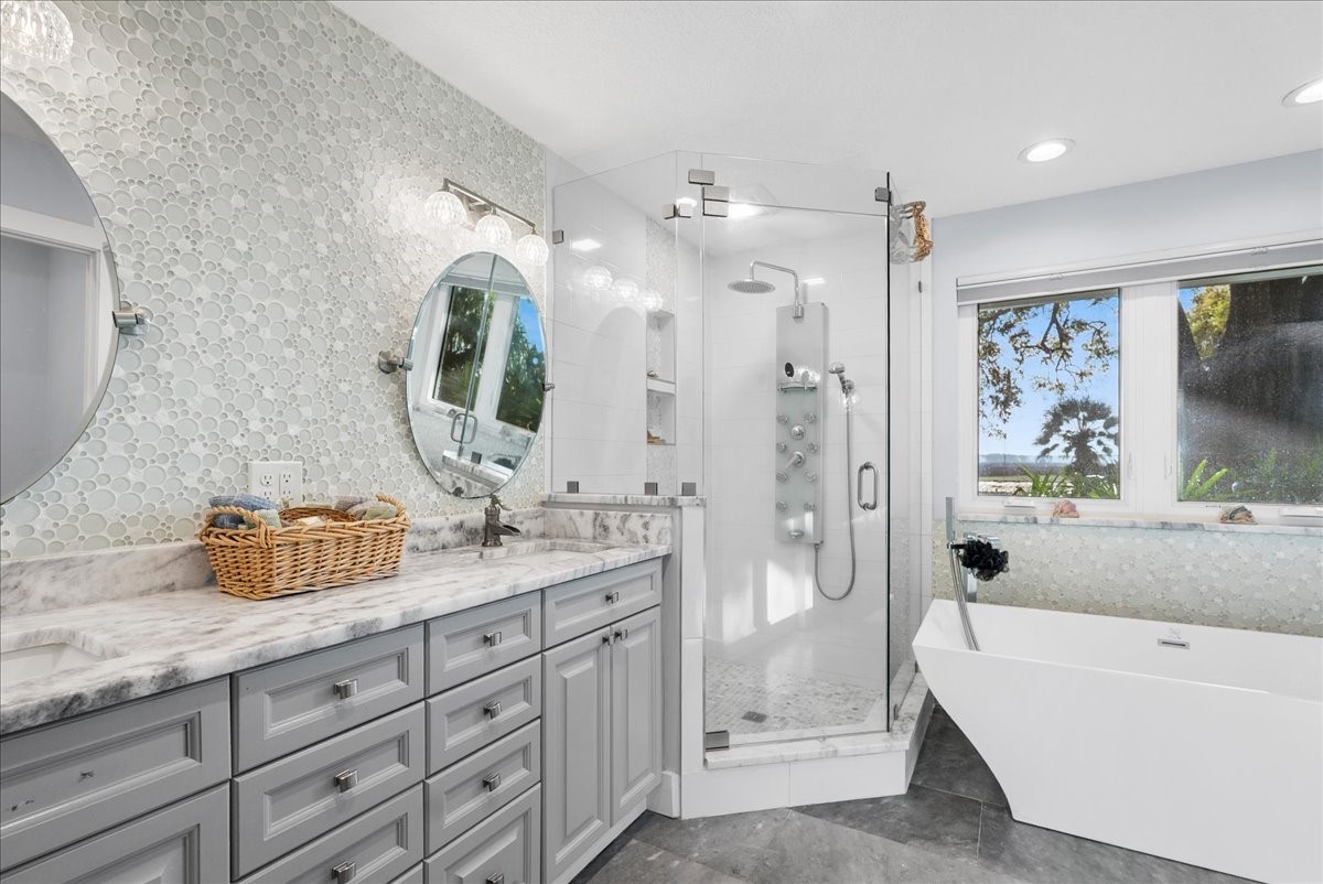85316 Avant Road Yulee, FL 32097 - Photo 27 of 62 a bathroom with a granite countertop double vanity sink mirror bathtub and shower
