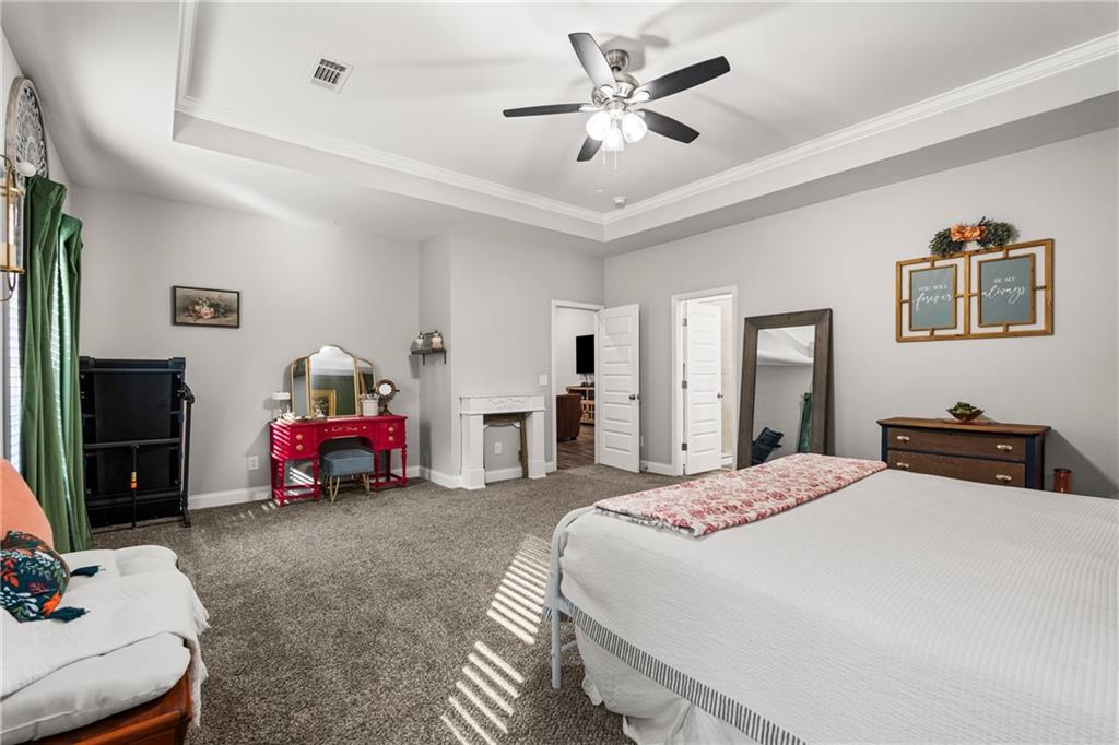 3696 Lee Road Salem, AL 36874 - Photo 21 of 36 Tray ceiling with crown molding, ceiling fan, neutral wall paint, and gray carpet flooring