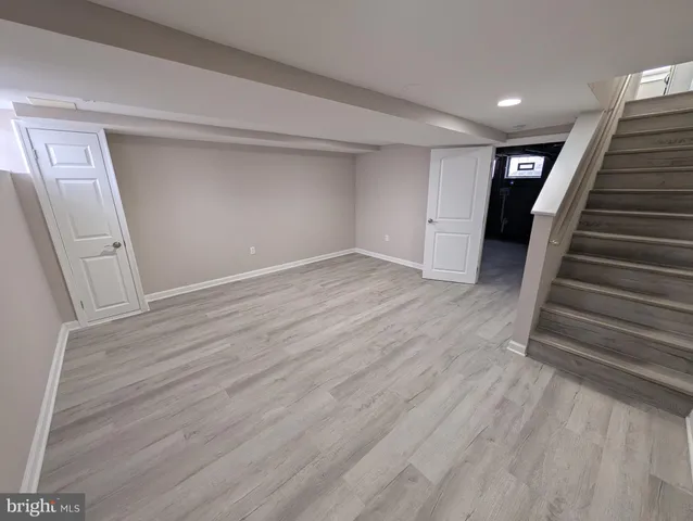wooden floor in an empty room with stairs