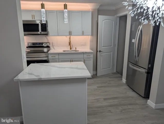 a kitchen with a refrigerator and a stove