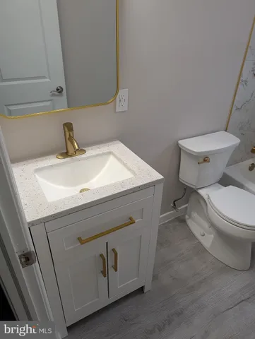 a bathroom with a sink toilet and vanity