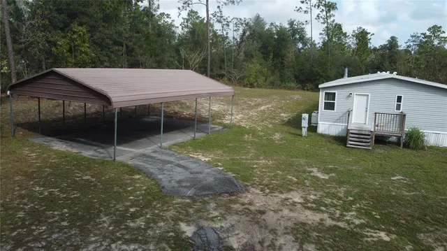 a backyard of a house with table and chairs