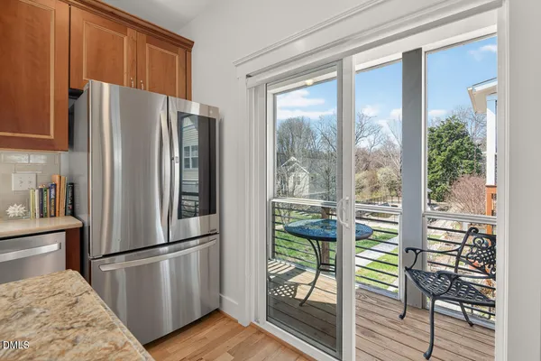 a view of a chairs and table in the balcony