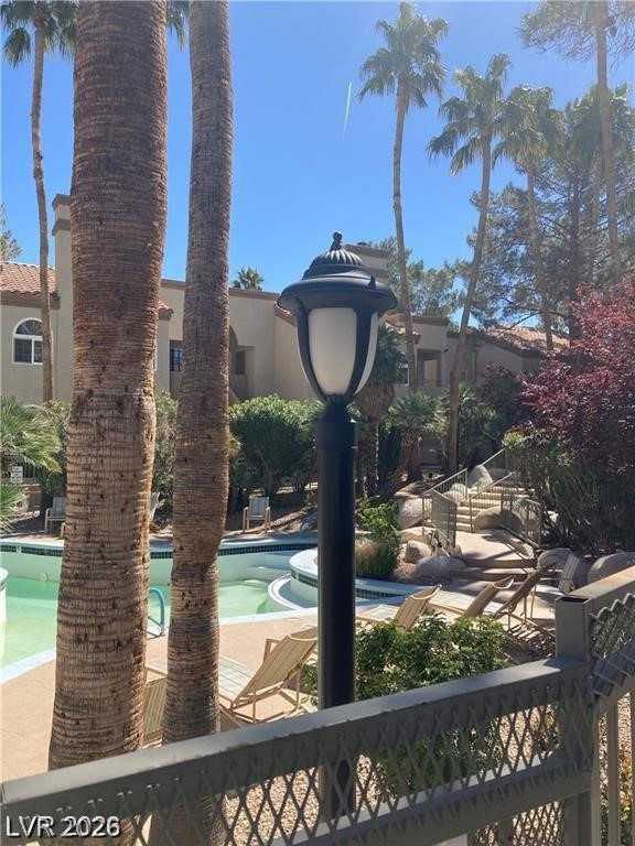 3145 East Flamingo Road, Unit 2100 Las Vegas, NV 89121 - Photo 32 of 34 A refreshing pool area framed by tall palms offers a tranquil escape.