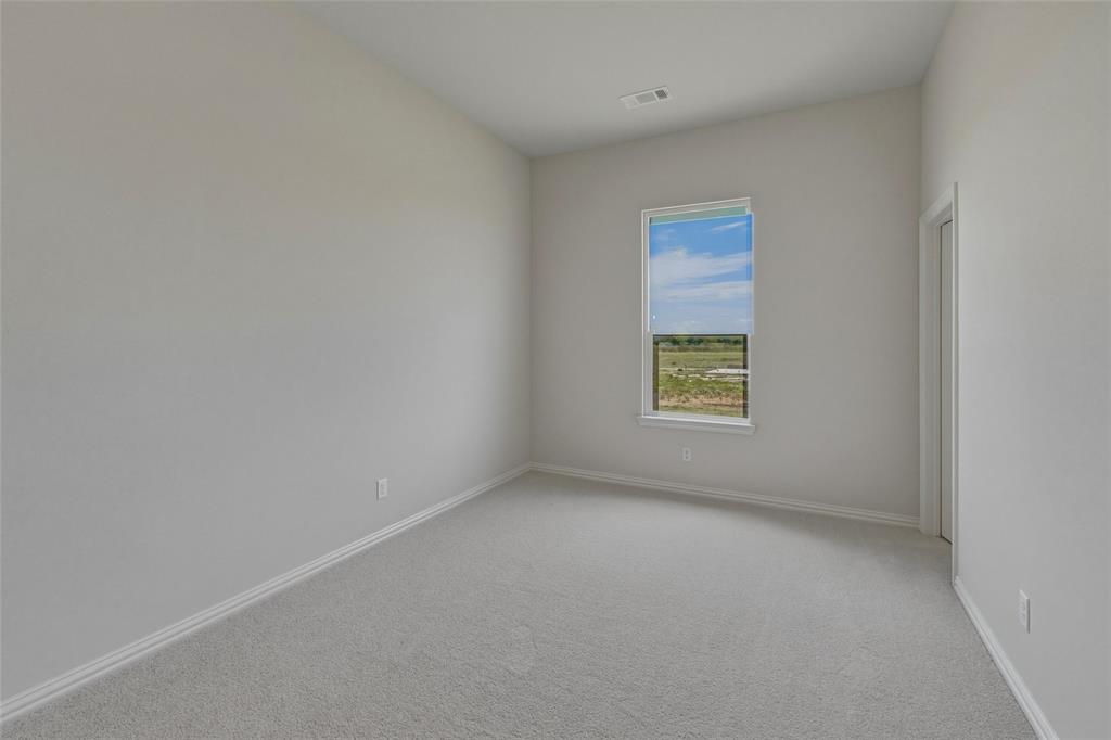 136 Hillview Trail Decatur, TX 76234 - Photo 18 of 26 Neutral wall tones with a single window, light-toned carpet, and white trim