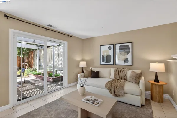 a living room with furniture and a lamp