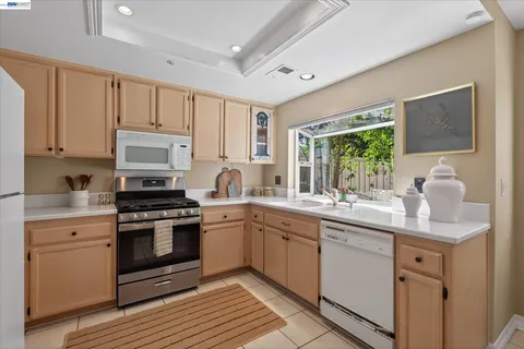 a kitchen with a sink stove and microwave