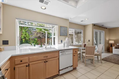 a kitchen with a sink and chairs