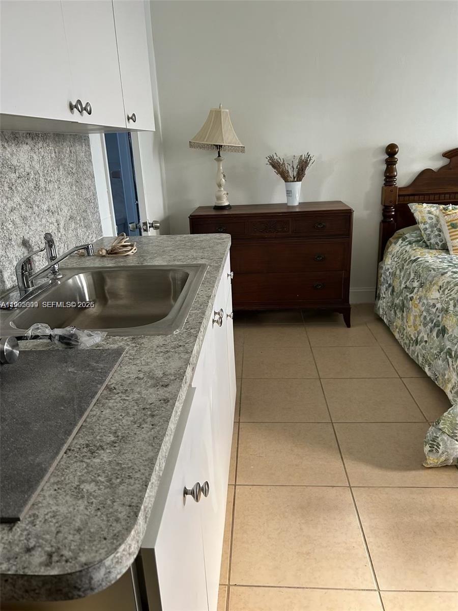 9525 Southwest 16th Street, Unit A Miami, FL 33165 - Photo 4 of 7 a kitchen with a sink and a stove top oven