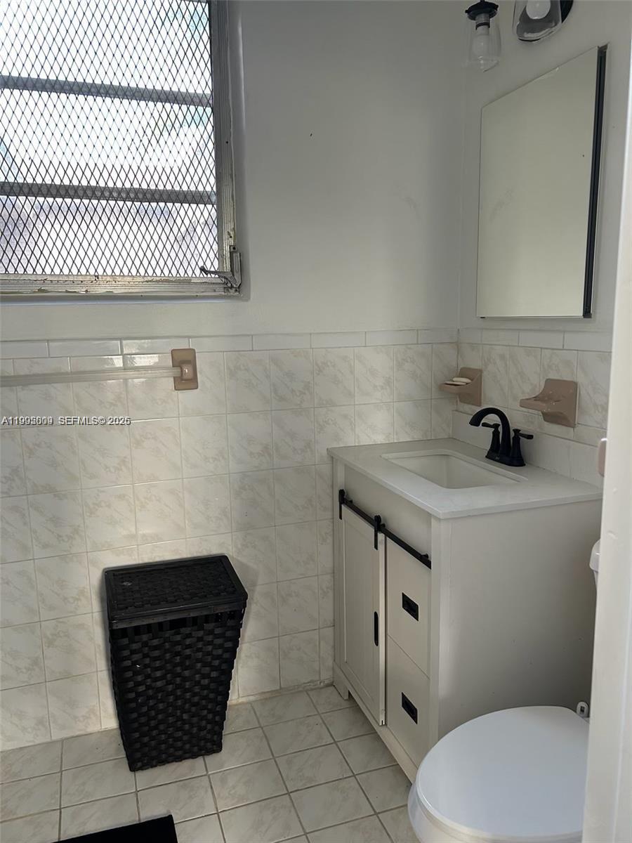 9525 Southwest 16th Street, Unit A Miami, FL 33165 - Photo 7 of 7 a bathroom with a sink a toilet and mirror