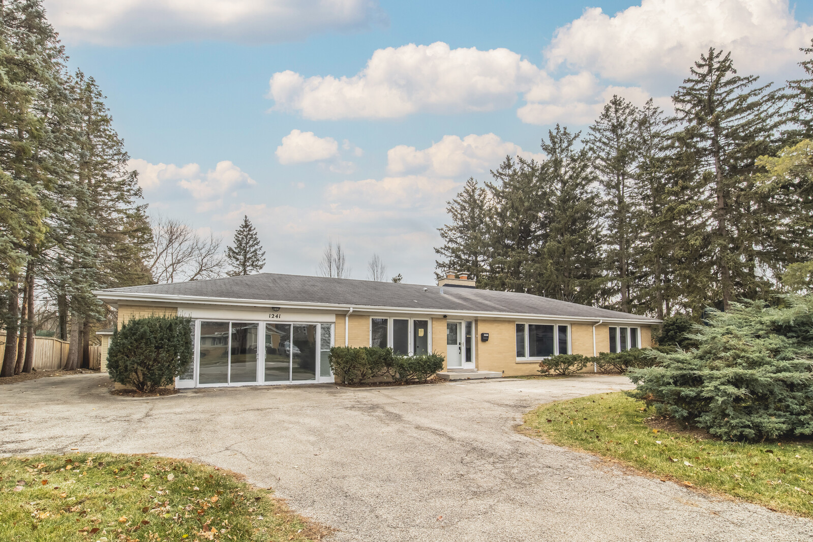a front view of a house with a garden