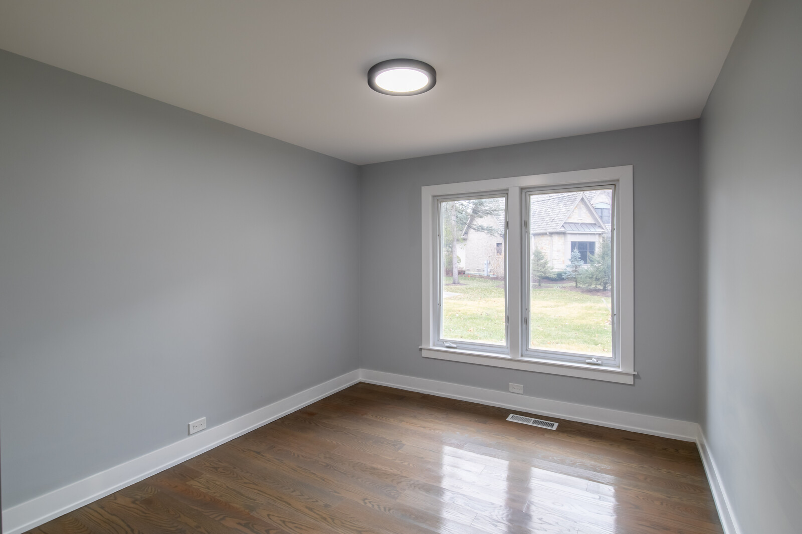 1241 Deerfield Road Deerfield, IL 60015 - Photo 17 of 37 an empty room with wooden floor and windows