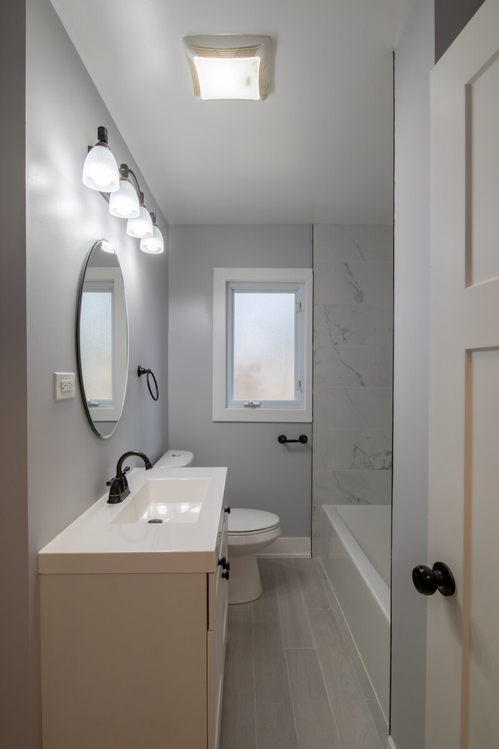 1241 Deerfield Road Deerfield, IL 60015 - Photo 24 of 37 a bathroom with a sink a toilet and a mirror