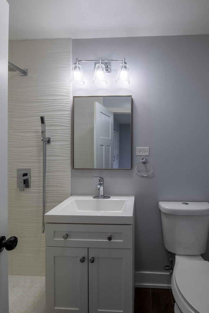 1241 Deerfield Road Deerfield, IL 60015 - Photo 25 of 37 a bathroom with a sink toilet and mirror