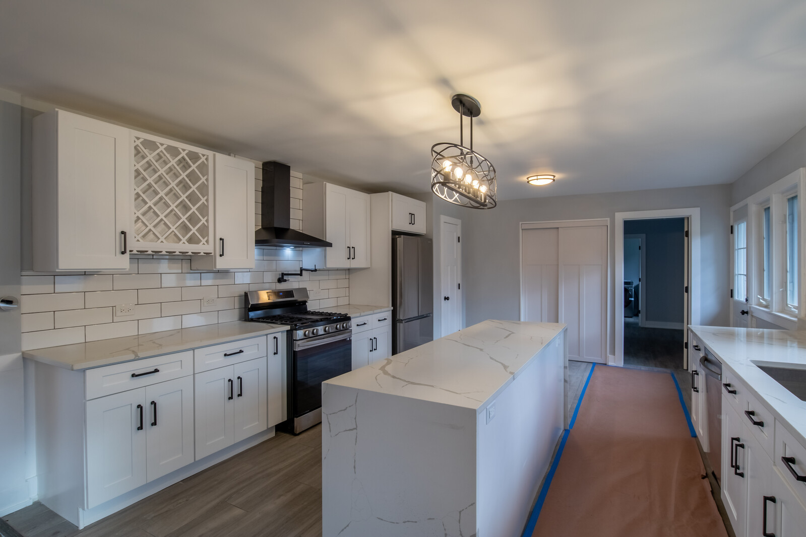 1241 Deerfield Road Deerfield, IL 60015 - Photo 9 of 37 a large kitchen with stainless steel appliances kitchen island a stove a sink dishwasher and a refrigerator with wooden floor