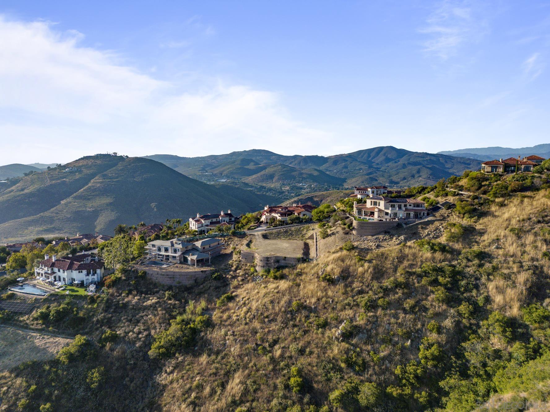 0 Camino De Arriba, Unit 148 Rancho Santa Fe, CA 92067 - Photo 11 of 17 a view of a lush green field with mountains in the background