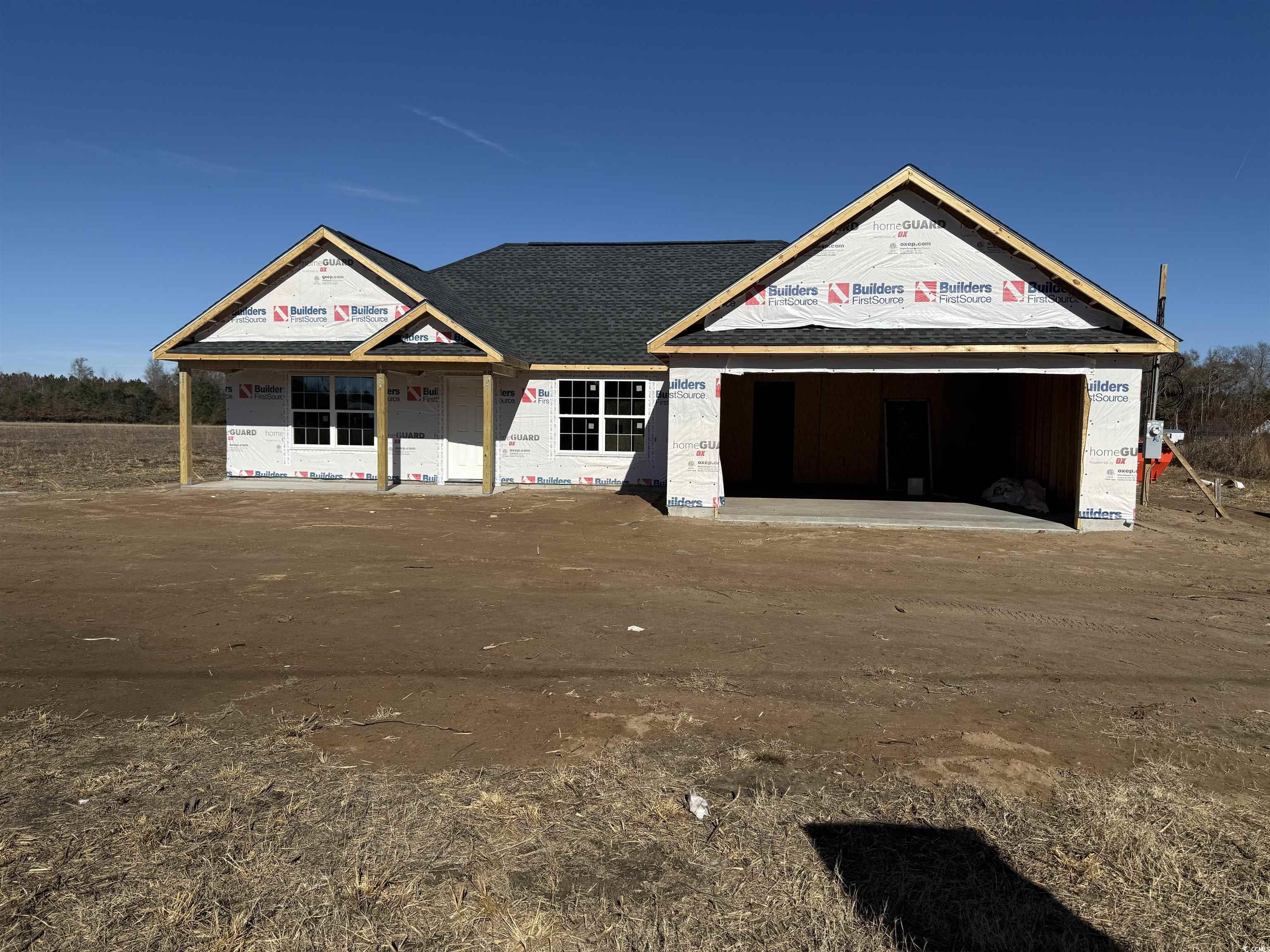 Unfinished property featuring a garage