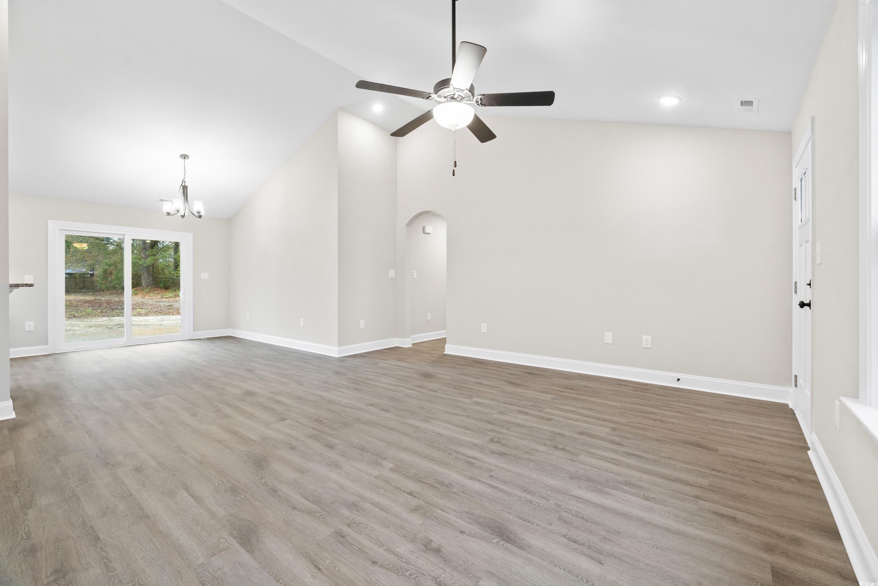 3646 Bethel Chapel Road Loris, SC 29569 - Photo 16 of 40 Unfurnished living room featuring light wood finished floors, a chandelier, a ceiling fan, recessed lighting, and arched walkways