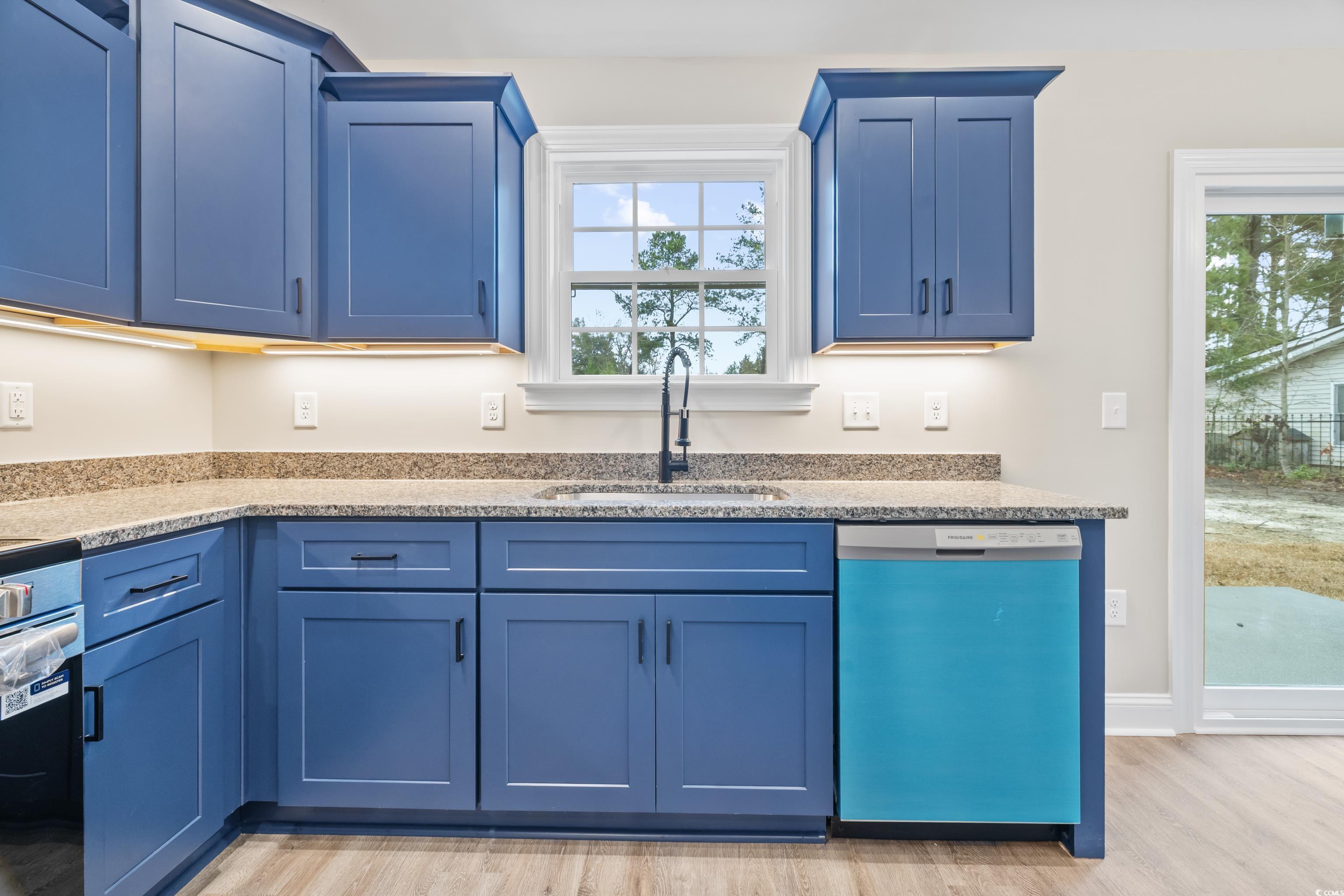 3646 Bethel Chapel Road Loris, SC 29569 - Photo 22 of 40 Kitchen with blue cabinets, dishwasher, light stone counters, and light wood-style flooring