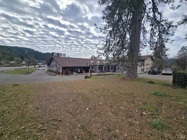 a view of house with outdoor space and sitting area