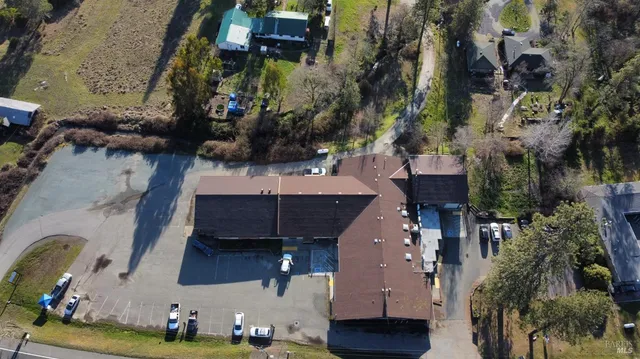 an aerial view of a house with a yard wooden house and outdoor seating