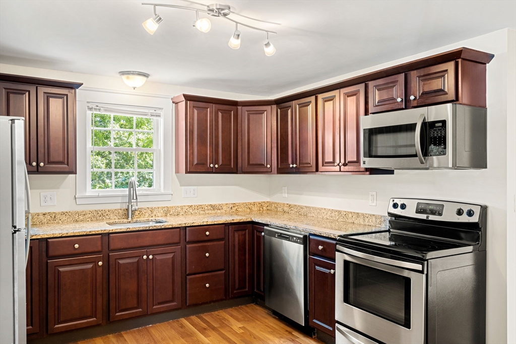 12 Chestnut Street Danvers, MA 01923 - Photo 30 of 37 a kitchen with granite countertop cabinets stainless steel appliances a sink and window