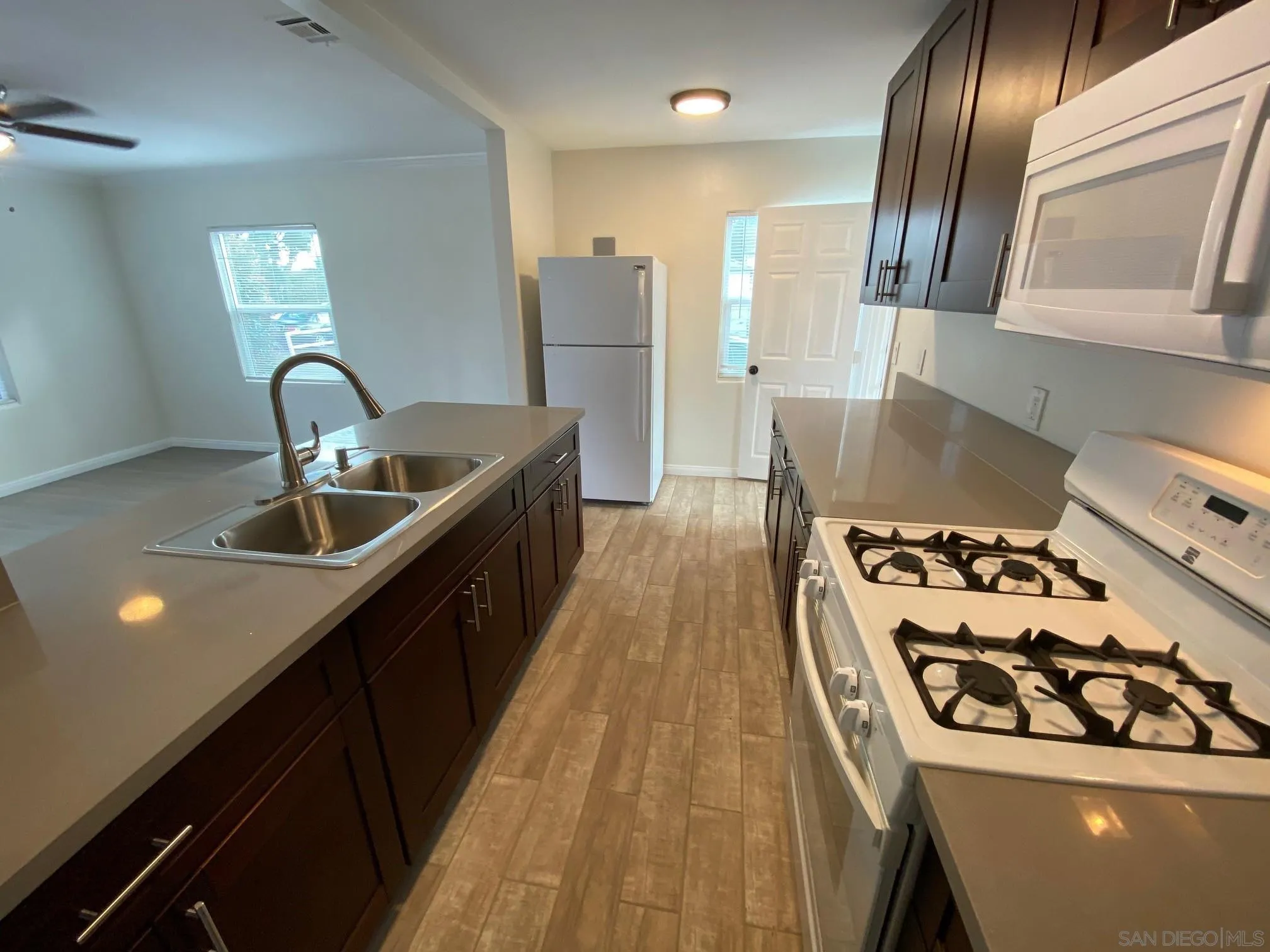 8975 Lamar Street Spring Valley, CA 91977 - Photo 25 of 59 a kitchen with kitchen island granite countertop a stove and a sink