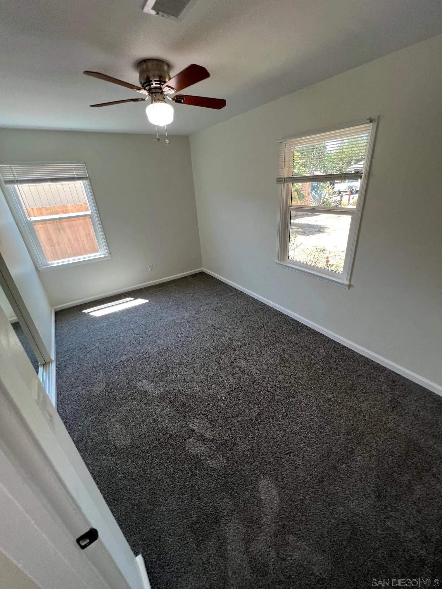 8975 Lamar Street Spring Valley, CA 91977 - Photo 54 of 59 a view of an empty room with window and chandelier fan
