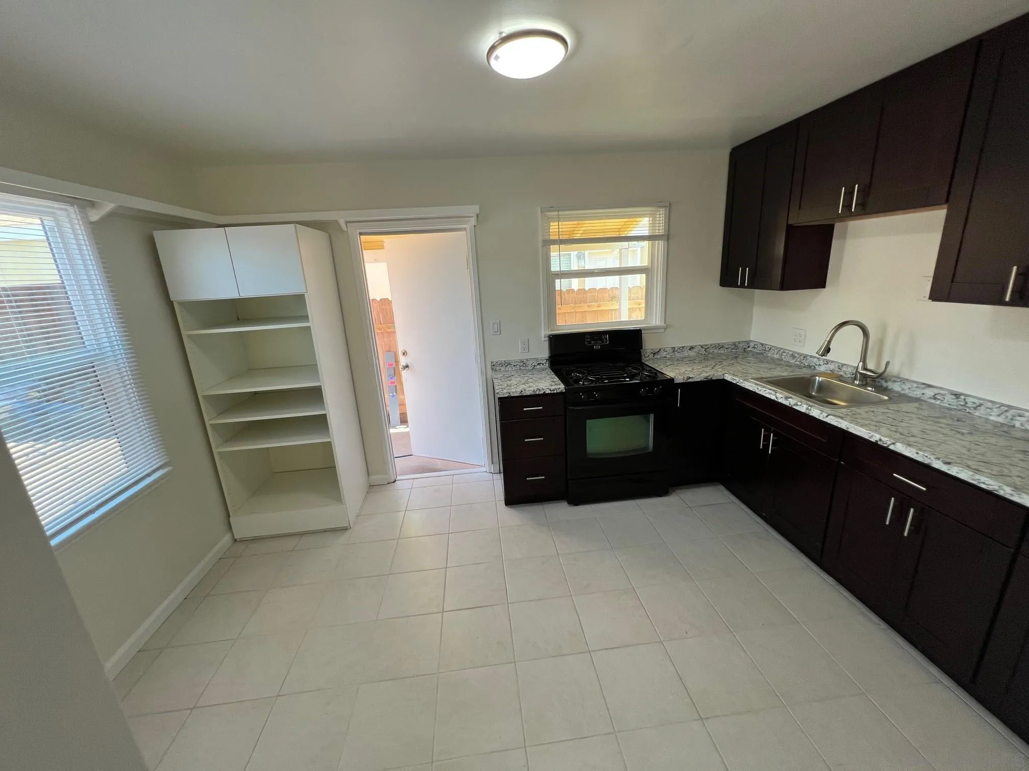 8975 Lamar Street Spring Valley, CA 91977 - Photo 55 of 59 a kitchen with a sink a stove and refrigerator