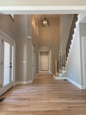 a view of a livingroom with wooden floor and stairs