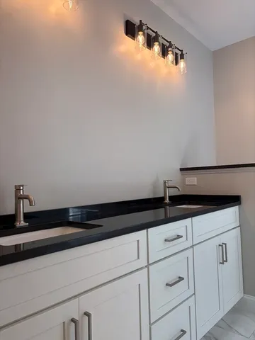 a close view of sink and cabinets