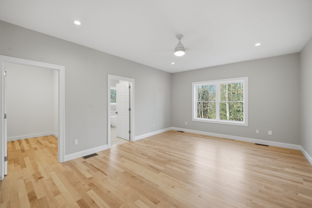 130 Linden Ridge Road Amherst, MA 01002 - Photo 19 of 40 a view of an empty room with wooden floor and a window