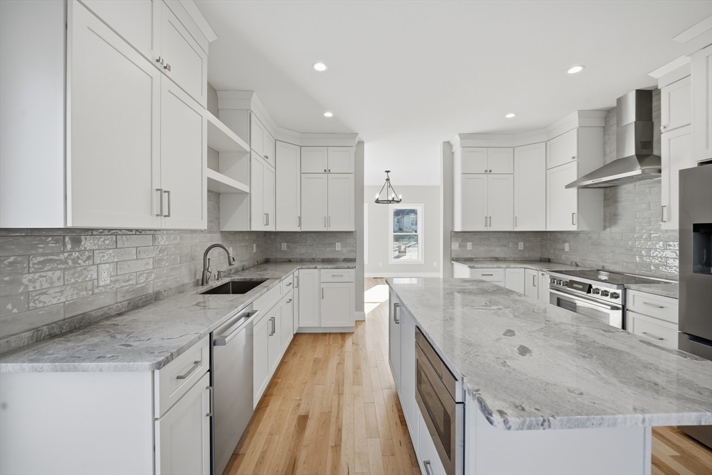 130 Linden Ridge Road Amherst, MA 01002 - Photo 20 of 40 a kitchen with stainless steel appliances granite countertop a sink stove and refrigerator