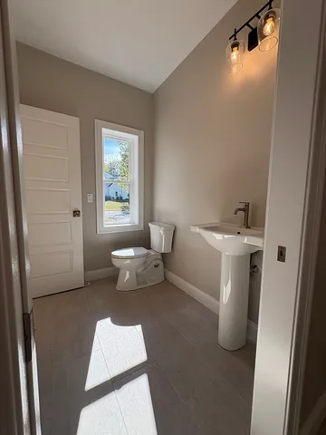 a view of staircase with wooden floor and white walls