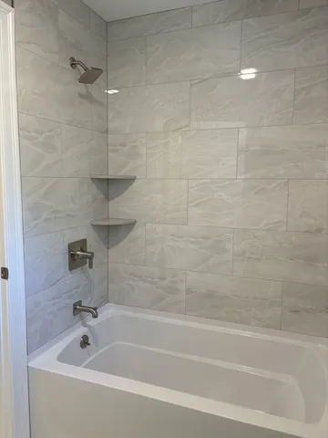 a white toilet sitting next to a window