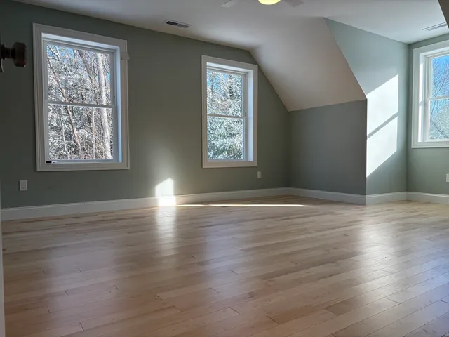 a view of a room with wooden floor and doors