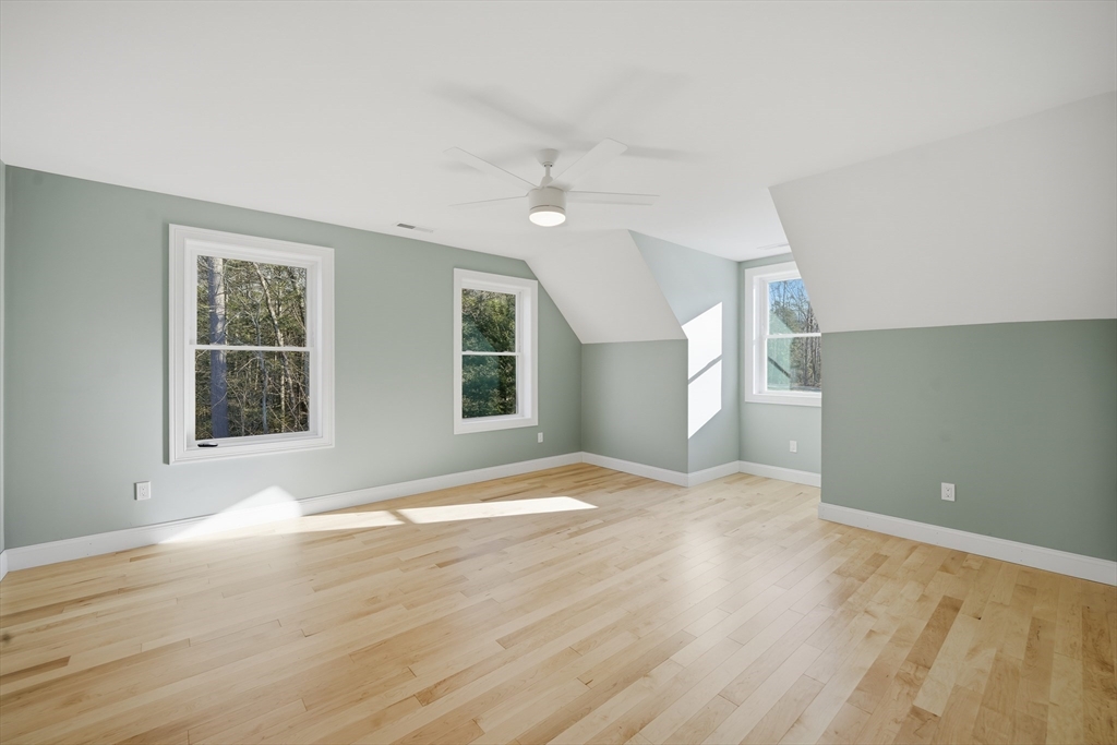 130 Linden Ridge Road Amherst, MA 01002 - Photo 28 of 40 a view of an empty room with wooden floor and a window