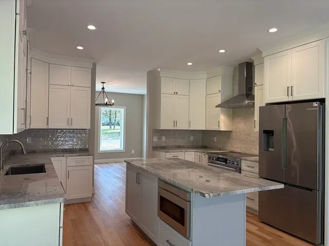 a kitchen with a sink a stove a refrigerator and a oven