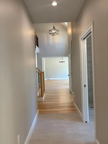 a view of entryway and hall with wooden floor