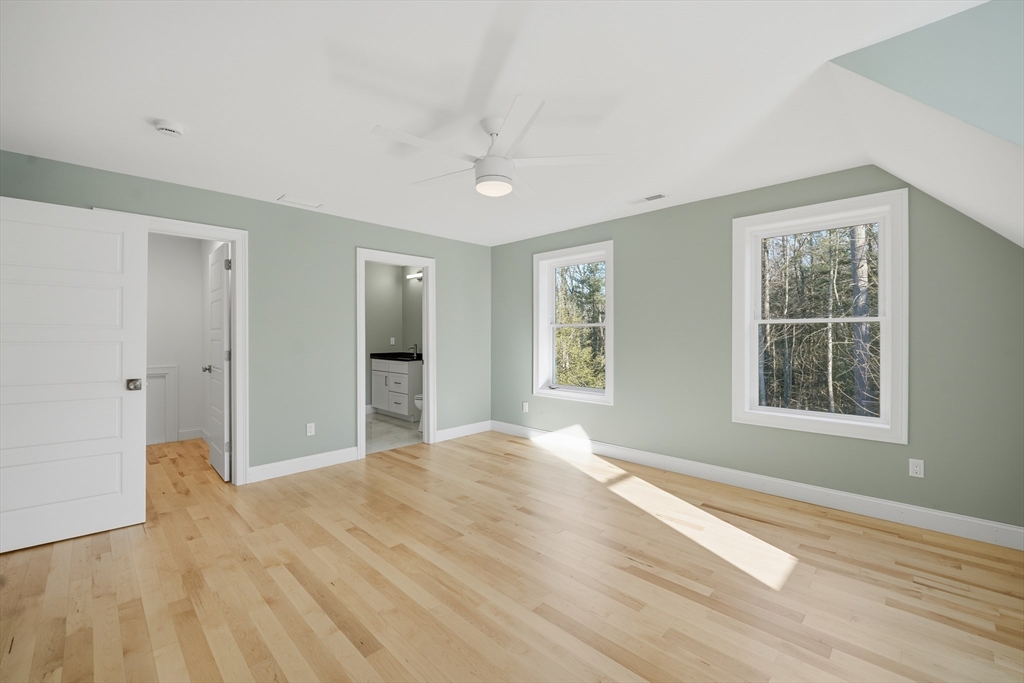 130 Linden Ridge Road Amherst, MA 01002 - Photo 32 of 40 a view of an empty room with wooden floor and a window