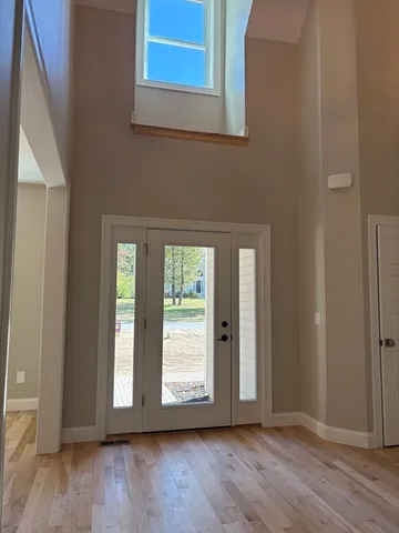 a kitchen with stainless steel appliances granite countertop a refrigerator a stove and a wooden floors