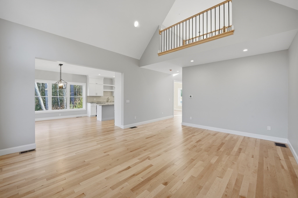 130 Linden Ridge Road Amherst, MA 01002 - Photo 7 of 40 a view of an empty room with wooden floor and a window