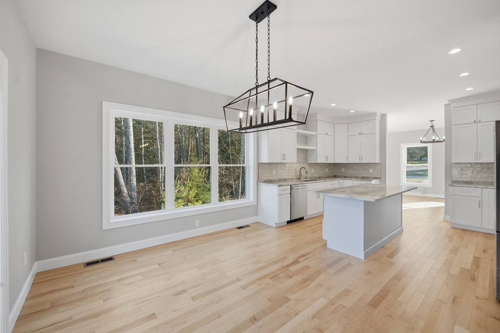 130 Linden Ridge Road Amherst, MA 01002 - Photo 8 of 40 a open kitchen with white cabinets and wooden floor