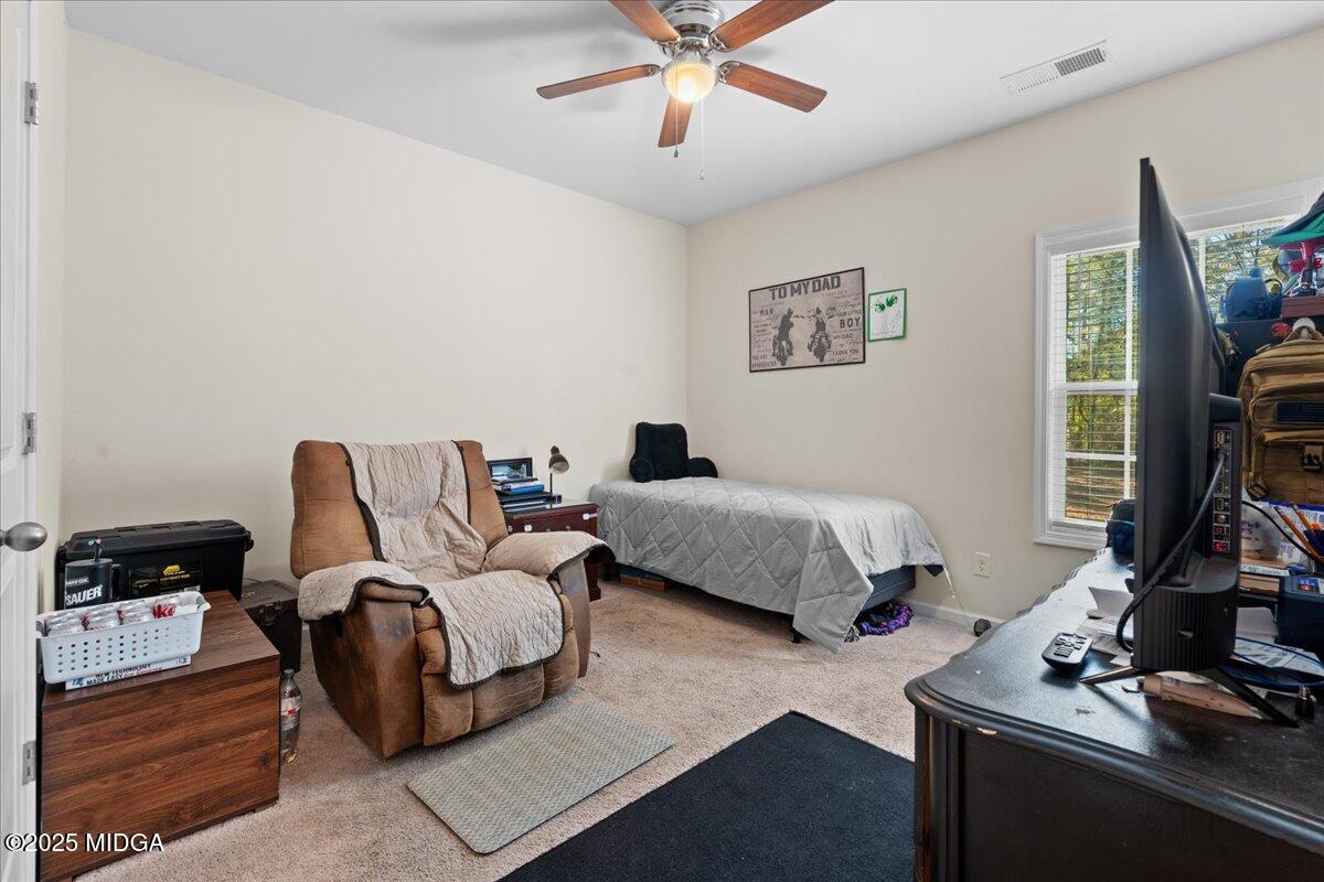 108 East E River Perry, GA 31069 - Photo 16 of 38 a bedroom with a bed and a flat screen tv